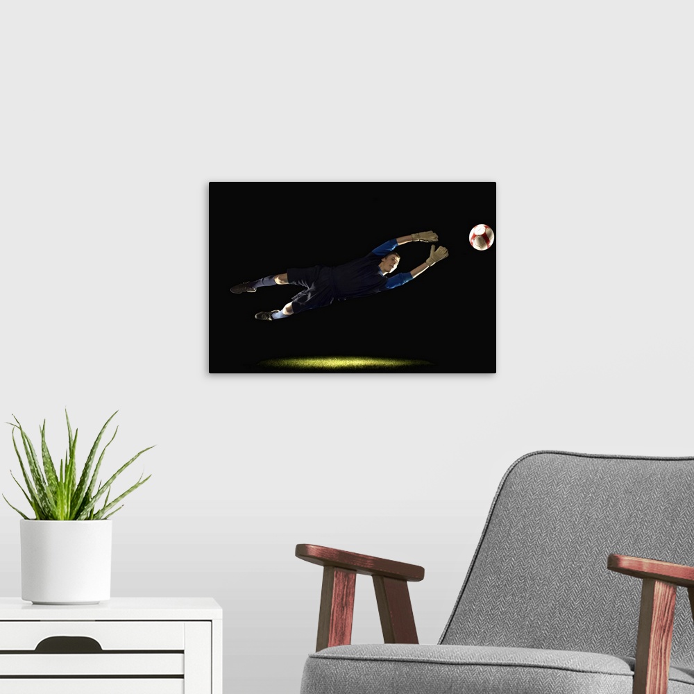 A modern room featuring Goalie leaping to get soccer ball