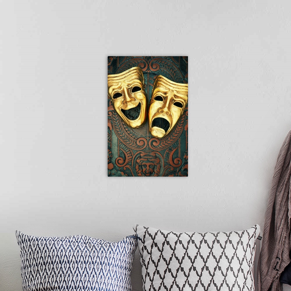 A bohemian room featuring Golden comedy and tragedy masks on patterned leather