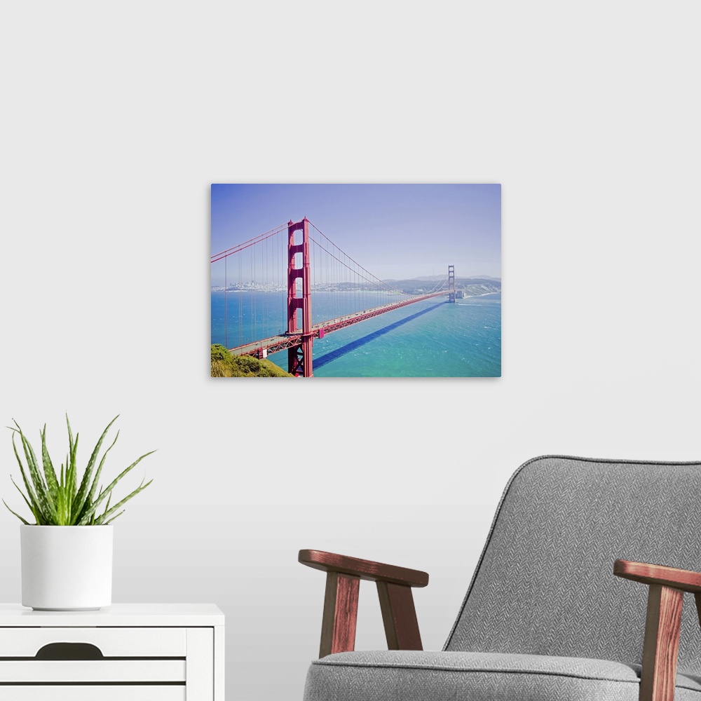 A modern room featuring A high angle photograph is taken of the Golden Gate bridge on a bright sunny day with a soft haze...