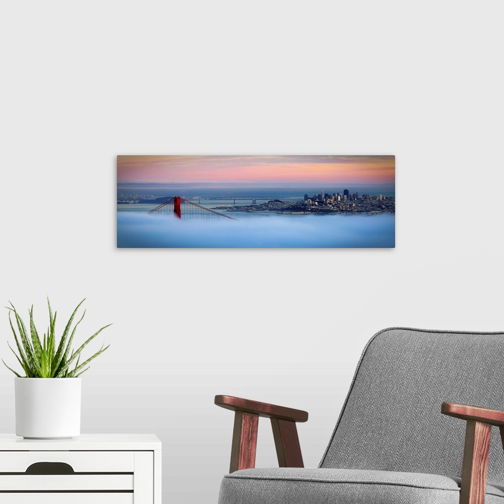 A modern room featuring Panoramic photo of one of the tops of the Golden Gate bridge peeking through the dense fog with t...