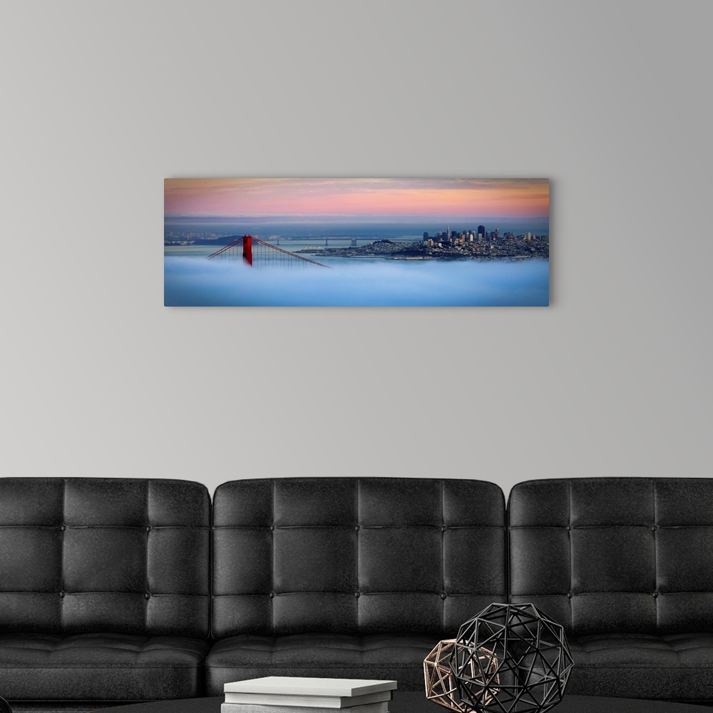 A modern room featuring Panoramic photo of one of the tops of the Golden Gate bridge peeking through the dense fog with t...