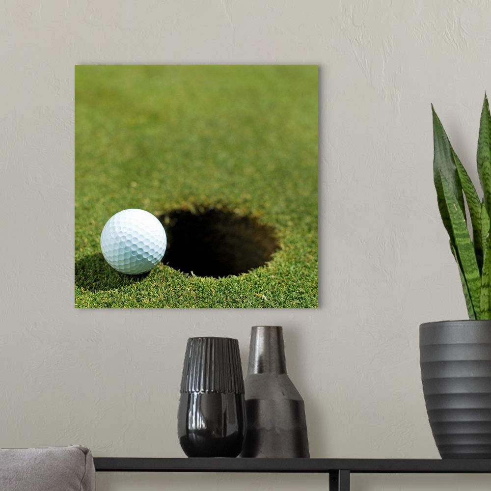 A modern room featuring Golf ball on the edge of the hole