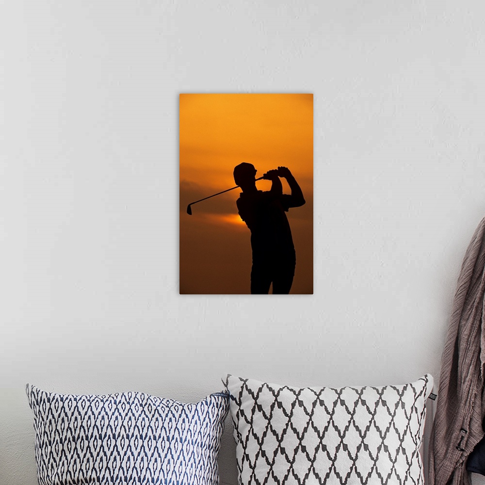 A bohemian room featuring Golfer silhouetted by sunset