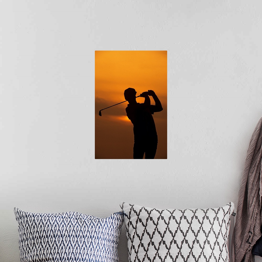 A bohemian room featuring Golfer silhouetted by sunset