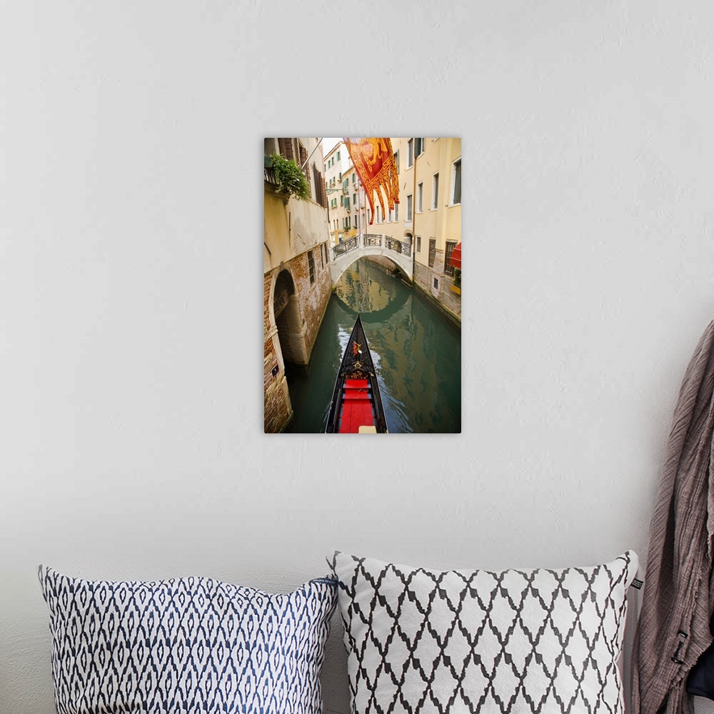 A bohemian room featuring Solitary gondola in narrow canal about to pass under a pedestrian bridge
