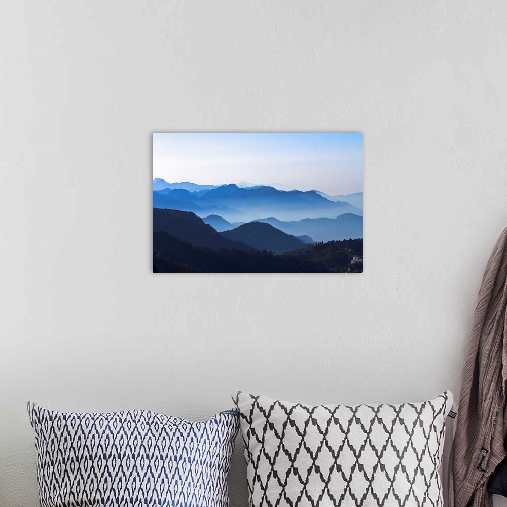 A bohemian room featuring Good layers of Mountains with clear blue sky, slight mist on mountains. Wide Angle.