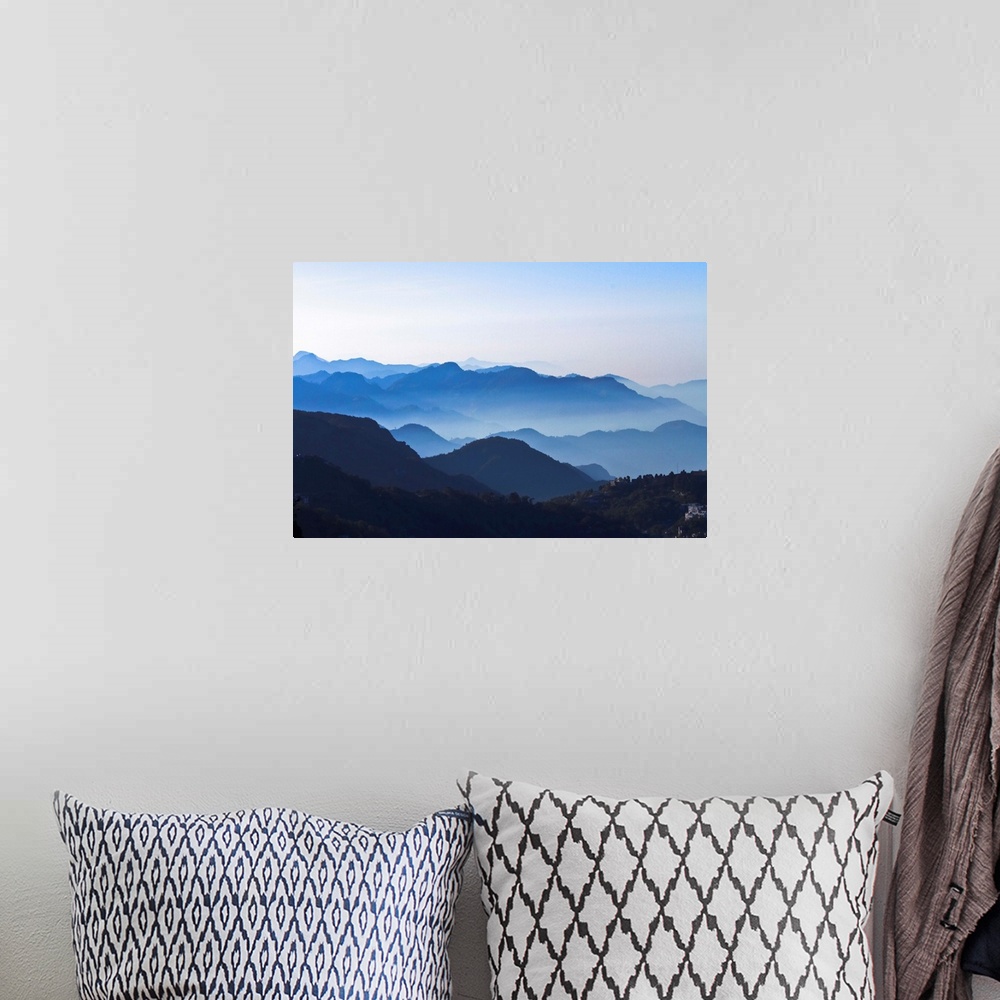 A bohemian room featuring Good layers of Mountains with clear blue sky, slight mist on mountains. Wide Angle.