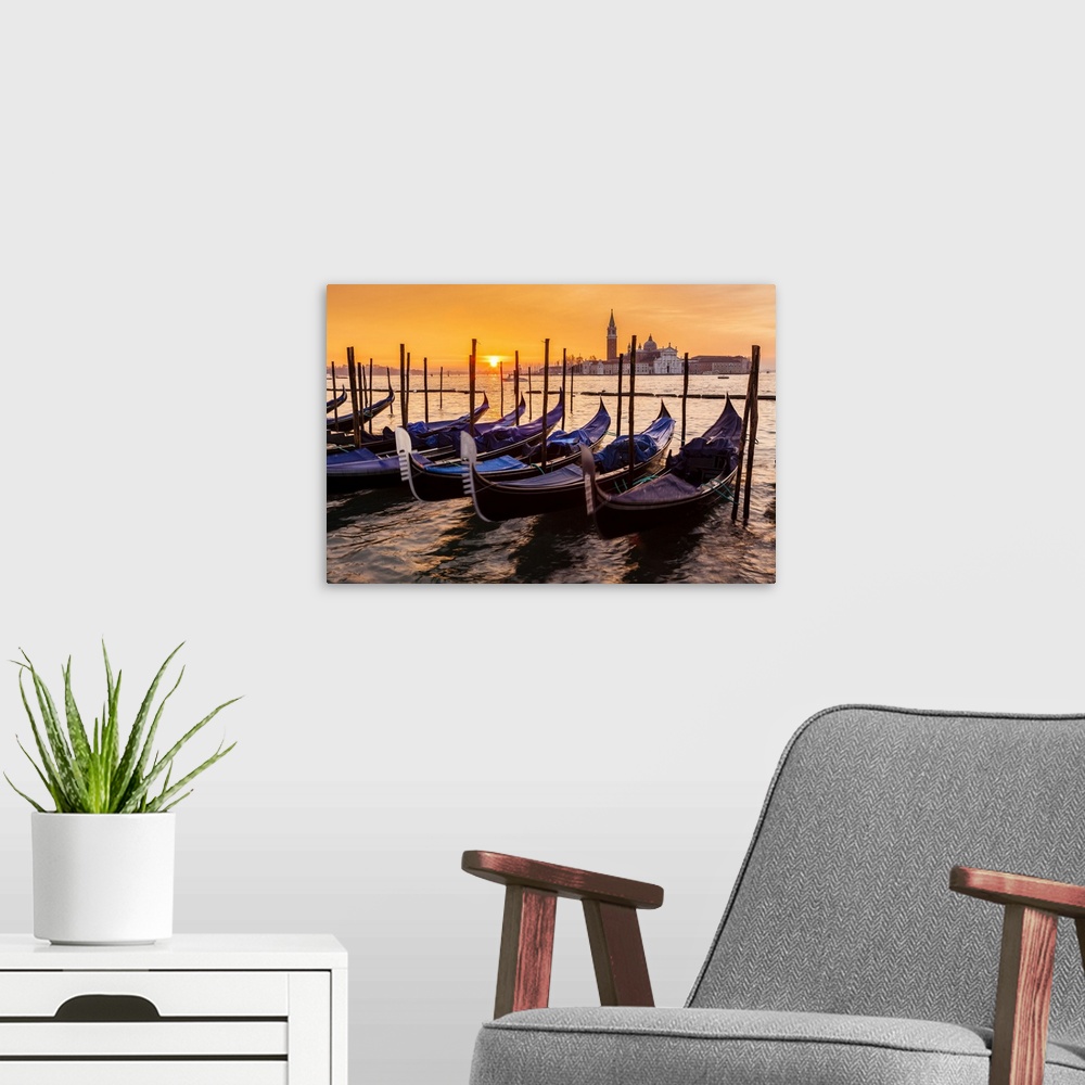 A modern room featuring Gondolas moored on Grand Canal and Church of San Giorgio Maggiore at sunrise.