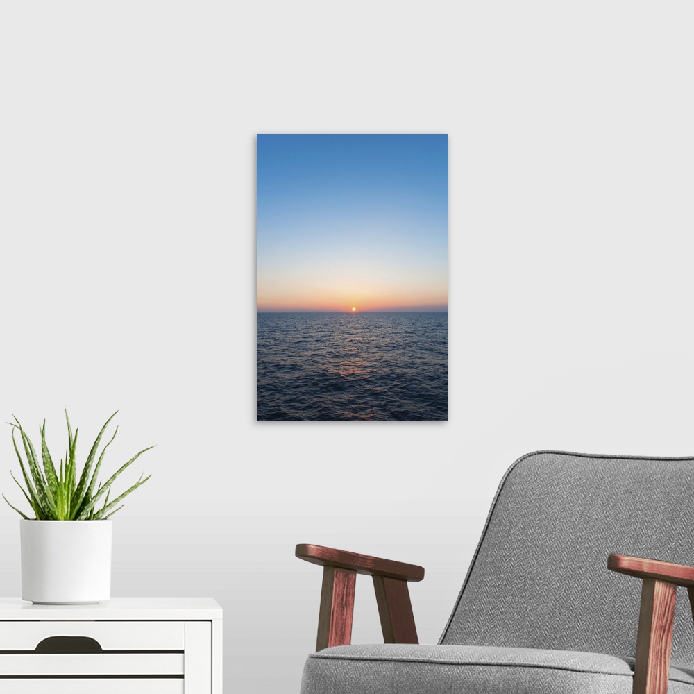 A modern room featuring Greece, Aegean Sea horizon at sunset