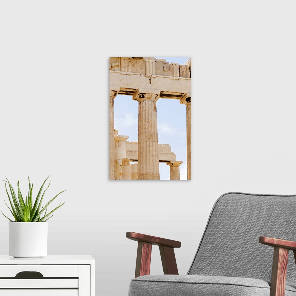A modern room featuring Vertical panoramic photograph of historic stone pillar ruins.