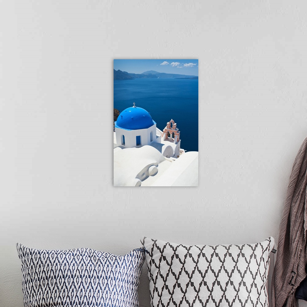 A bohemian room featuring Oversized, vertical, aerial photograph of the top of a church, overlooking blue waters over the c...