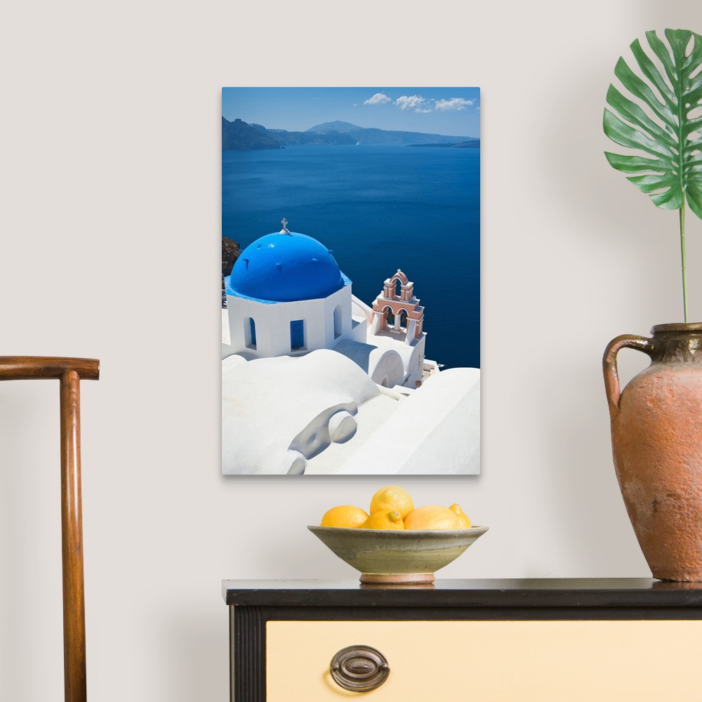 A traditional room featuring Oversized, vertical, aerial photograph of the top of a church, overlooking blue waters over the c...