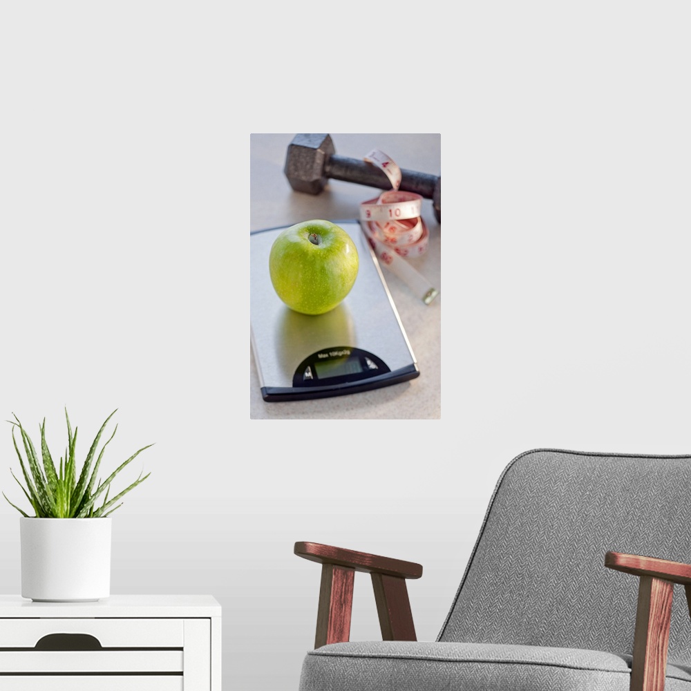 A modern room featuring Green apple on weight scale, tape measure and exercise weight in background