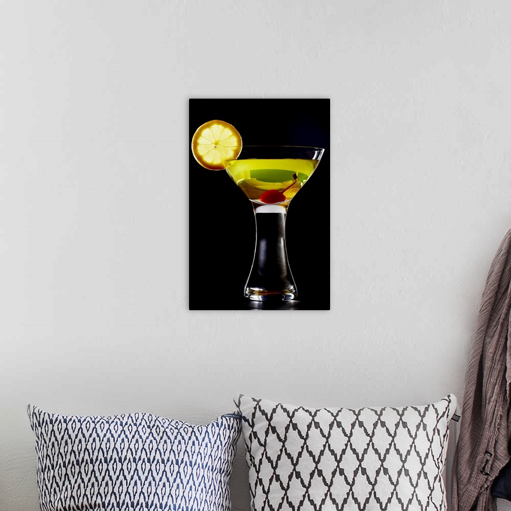 A bohemian room featuring Green coloured cocktail with cherry and orange slice, close-up