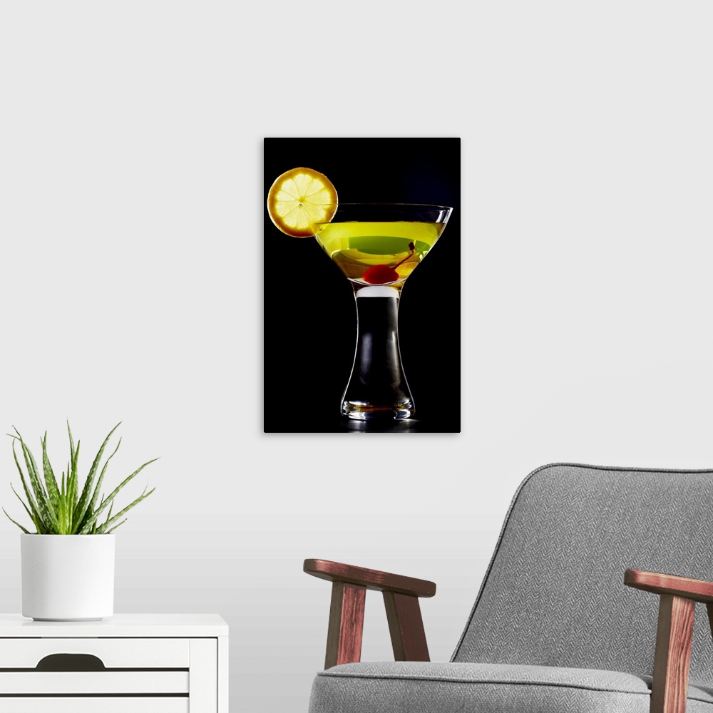 A modern room featuring Green coloured cocktail with cherry and orange slice, close-up