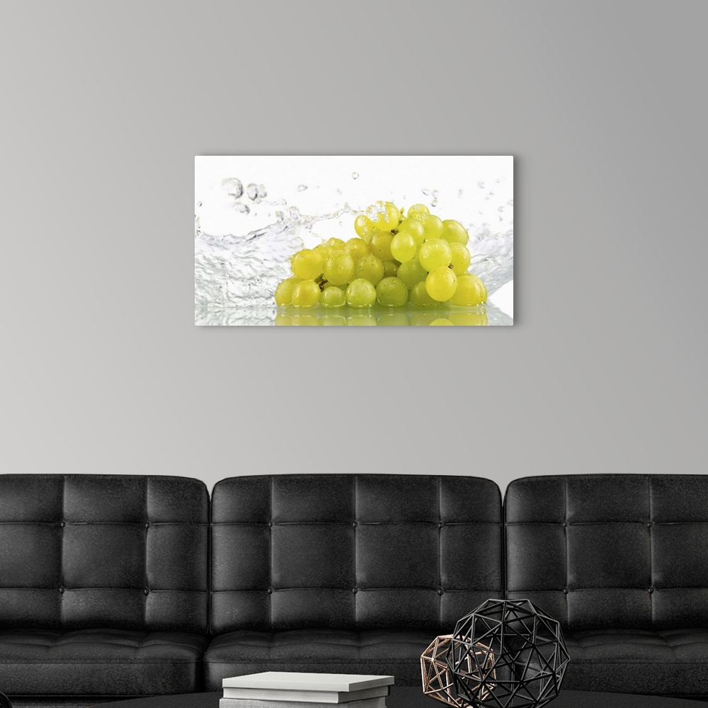 A modern room featuring Green grapes being washed in water