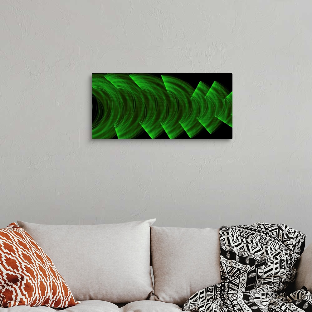 A bohemian room featuring Green light trails creating an abstract wave pattern on a black background