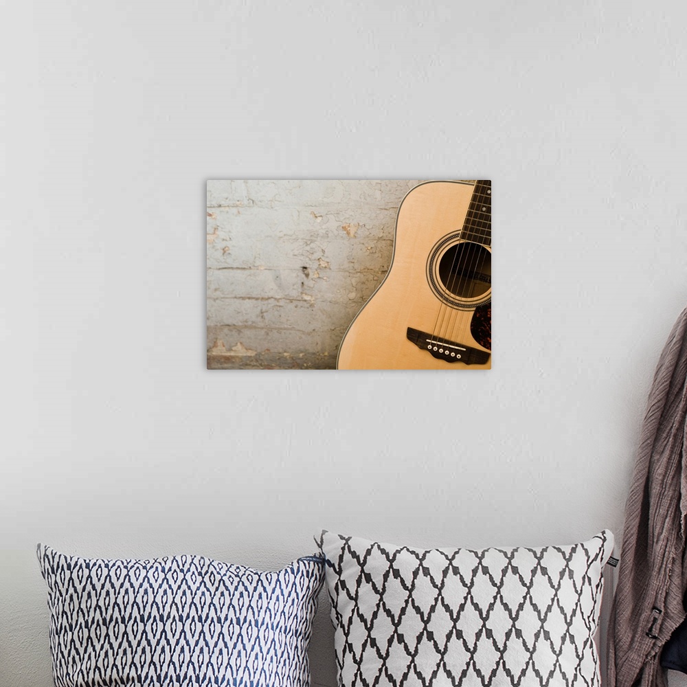 A bohemian room featuring Guitar and brick wall