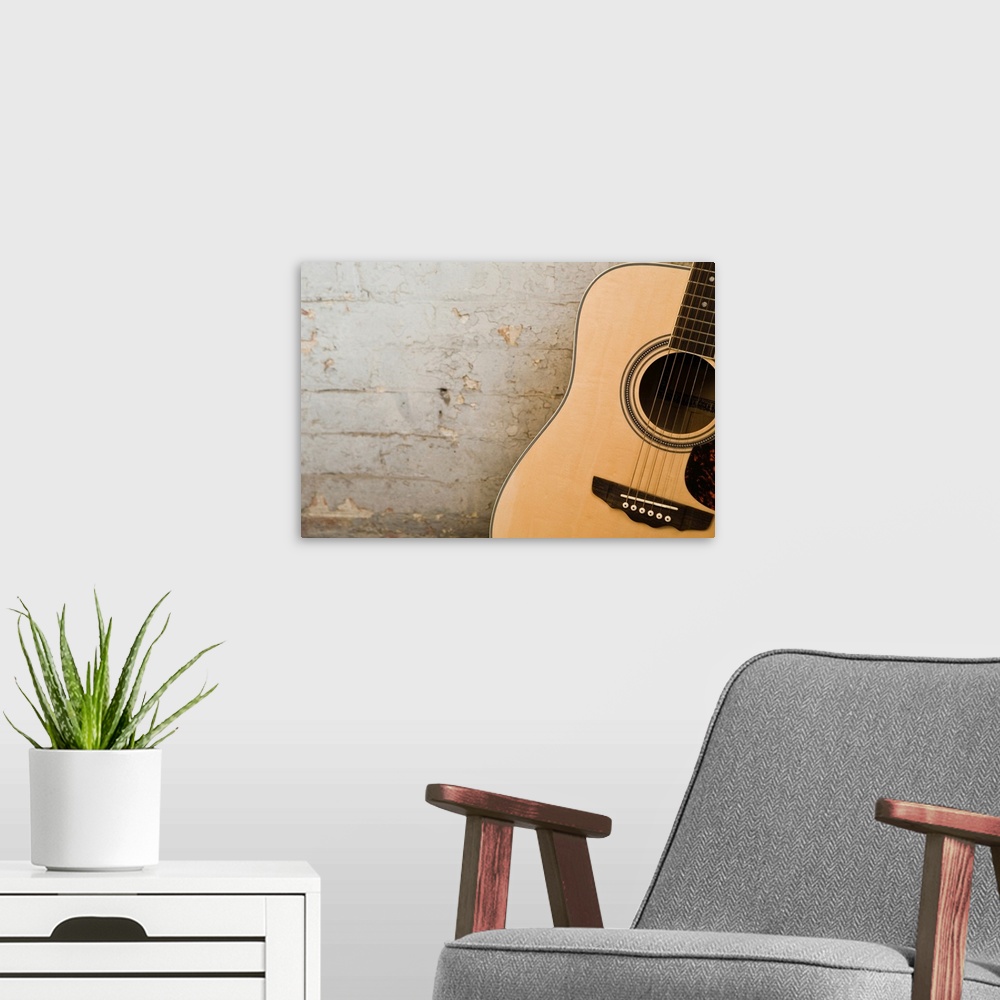 A modern room featuring Guitar and brick wall