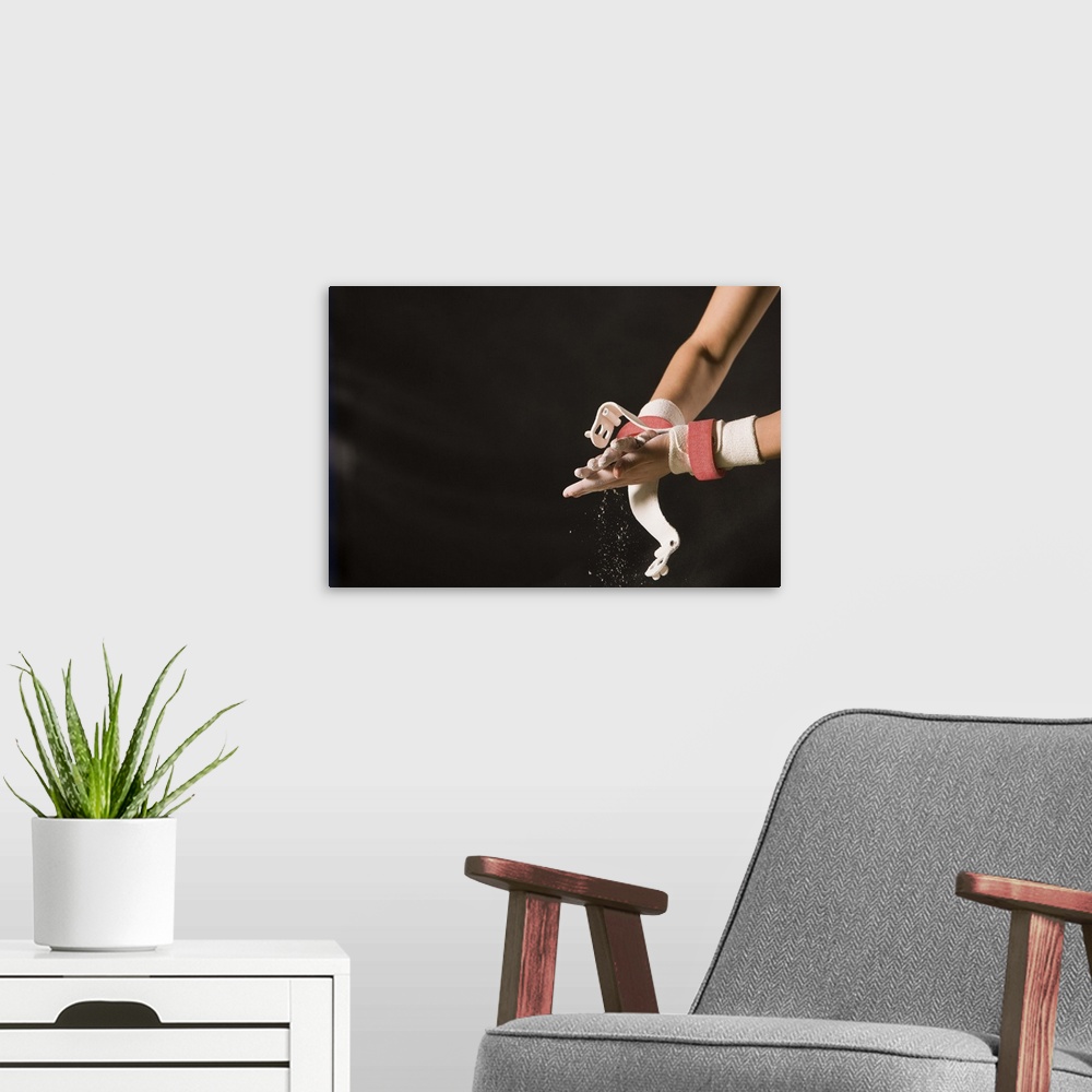 A modern room featuring Gymnast chalking up hands