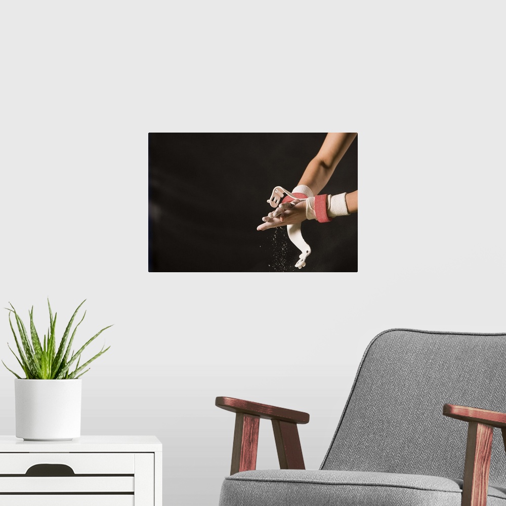 A modern room featuring Gymnast chalking up hands