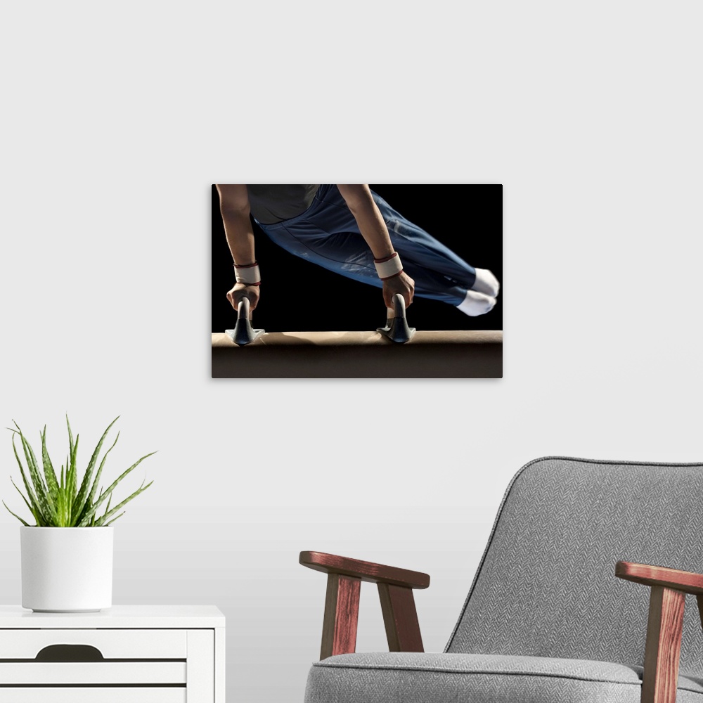 A modern room featuring Gymnast swinging on pommel horse