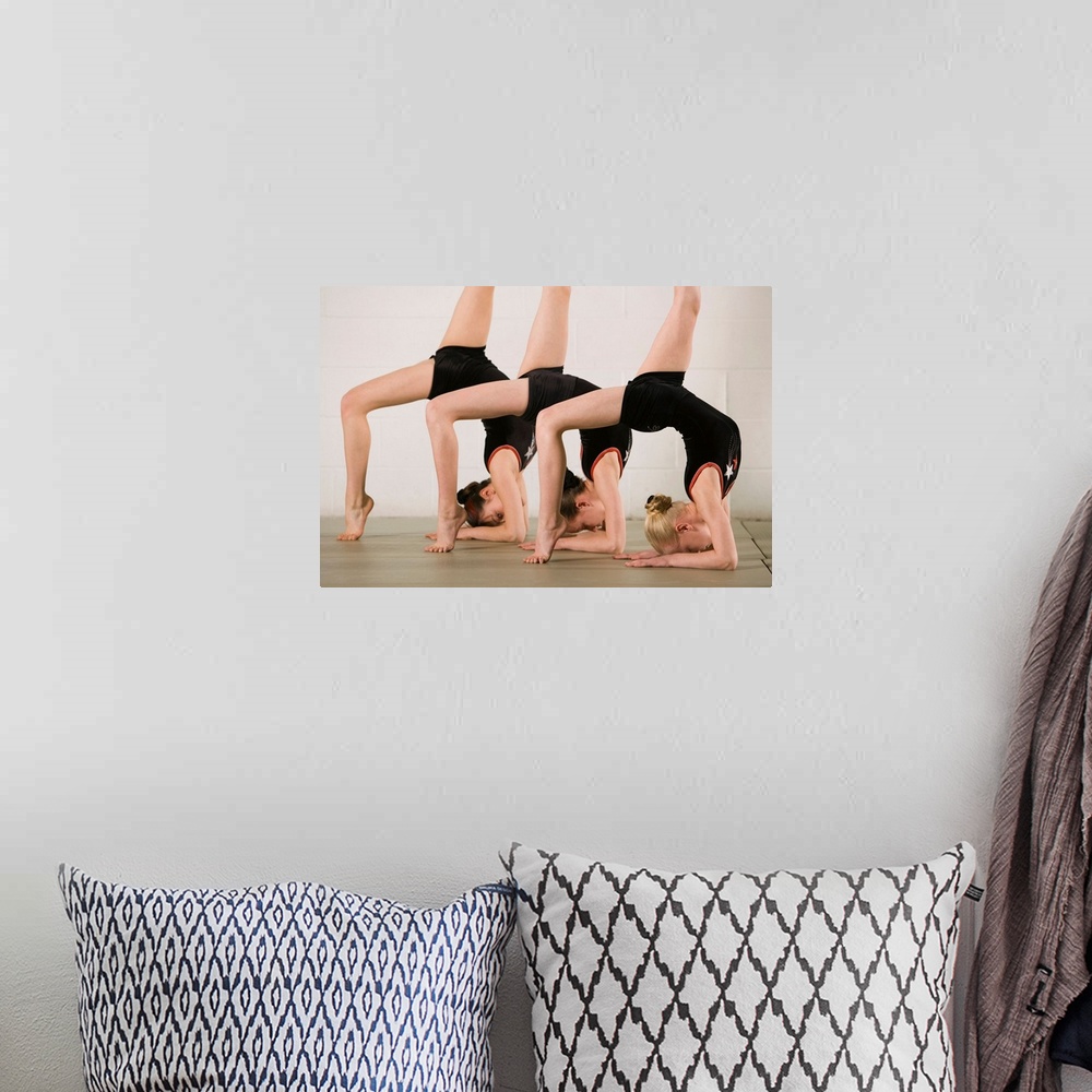 A bohemian room featuring Gymnasts posing upside down