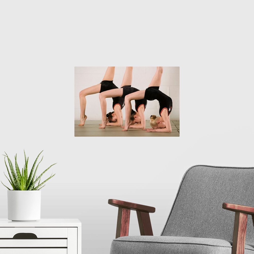 A modern room featuring Gymnasts posing upside down