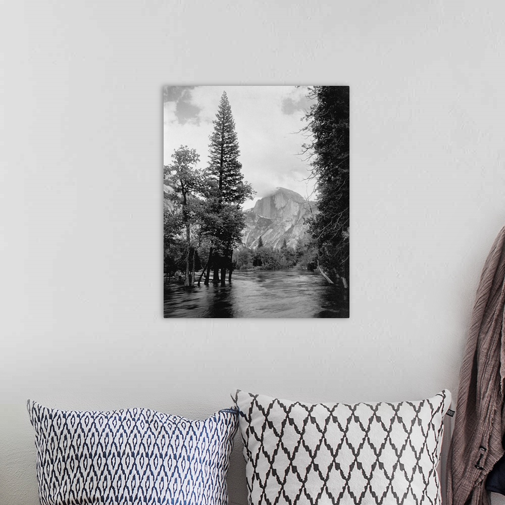 A bohemian room featuring Half Dome, one of Yosemite Park's most familiar landmarks, rises beyond the Merced River.