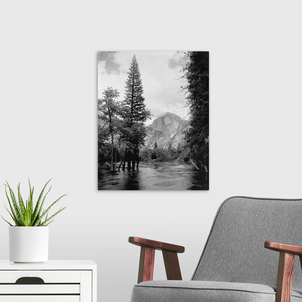 A modern room featuring Half Dome, one of Yosemite Park's most familiar landmarks, rises beyond the Merced River.
