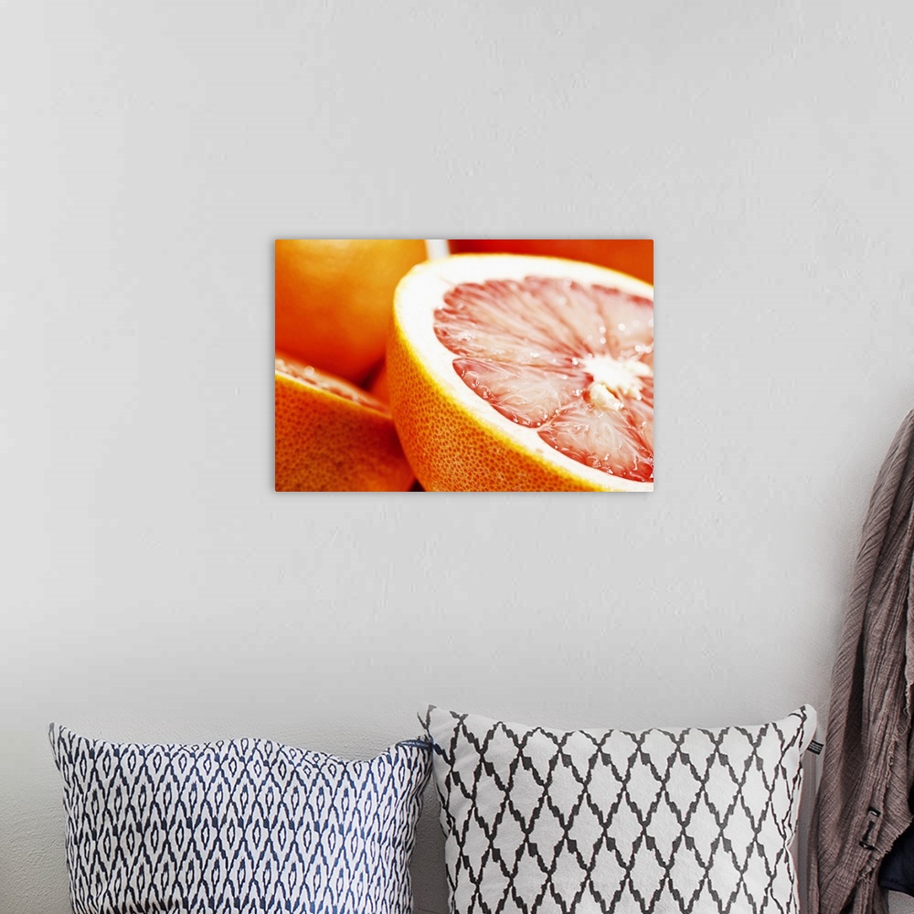 A bohemian room featuring Big, landscape, close up photograph of a grapefruit, sliced perfectly in half, the other half and...