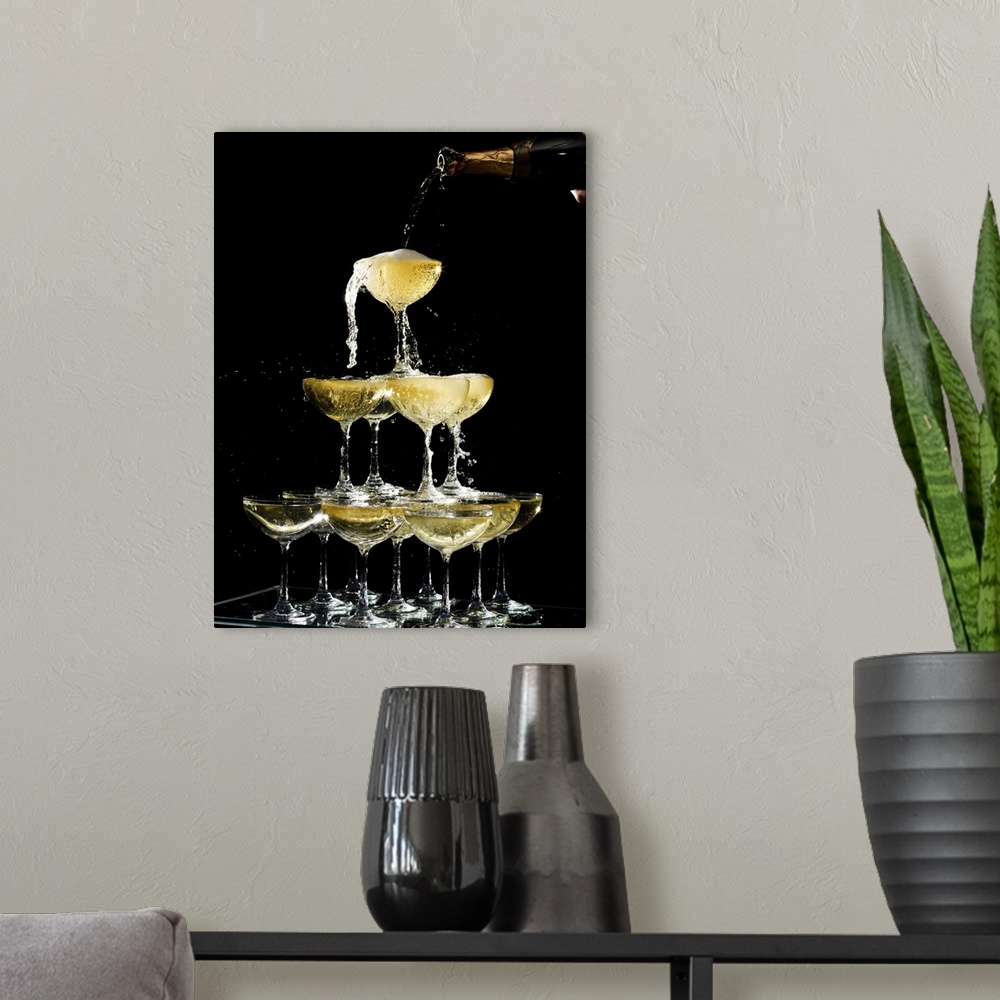 A modern room featuring Hand pouring a champagne fountain