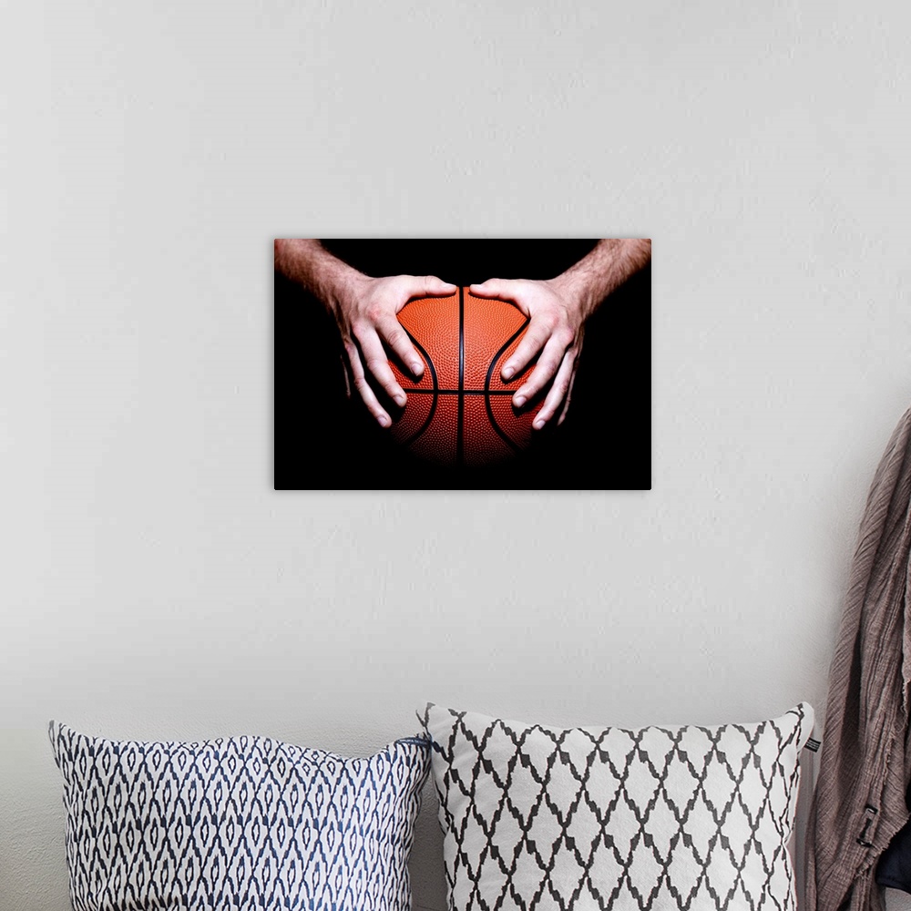 A bohemian room featuring Hands holding a basketball