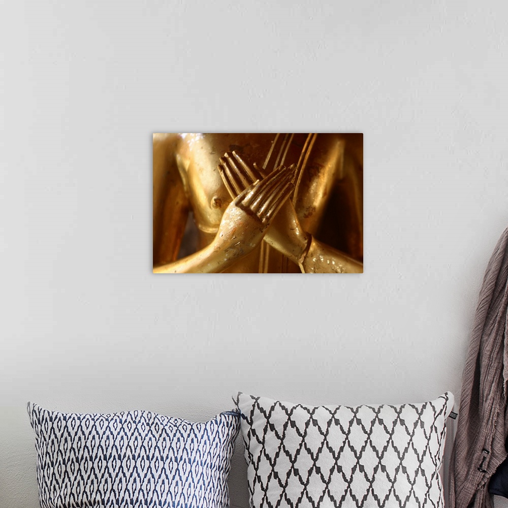 A bohemian room featuring Hands of golden statue crossed over chest