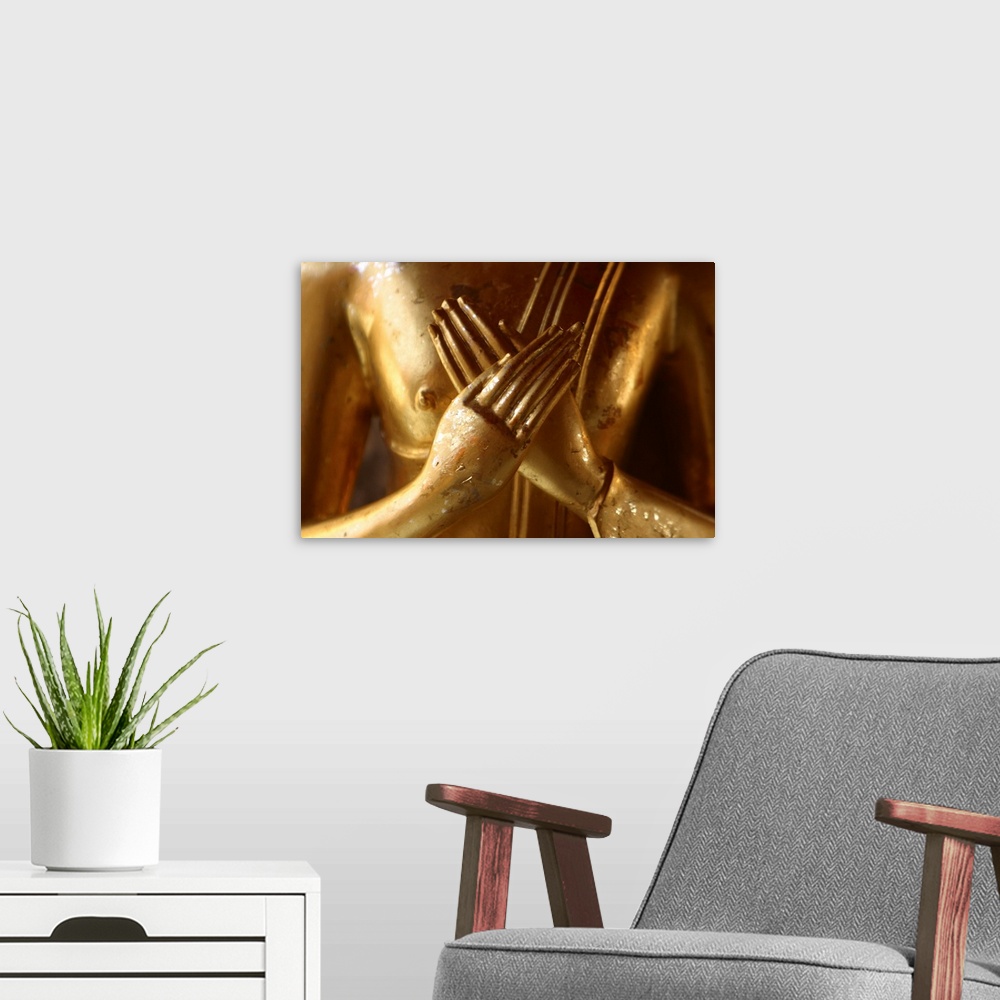 A modern room featuring Hands of golden statue crossed over chest
