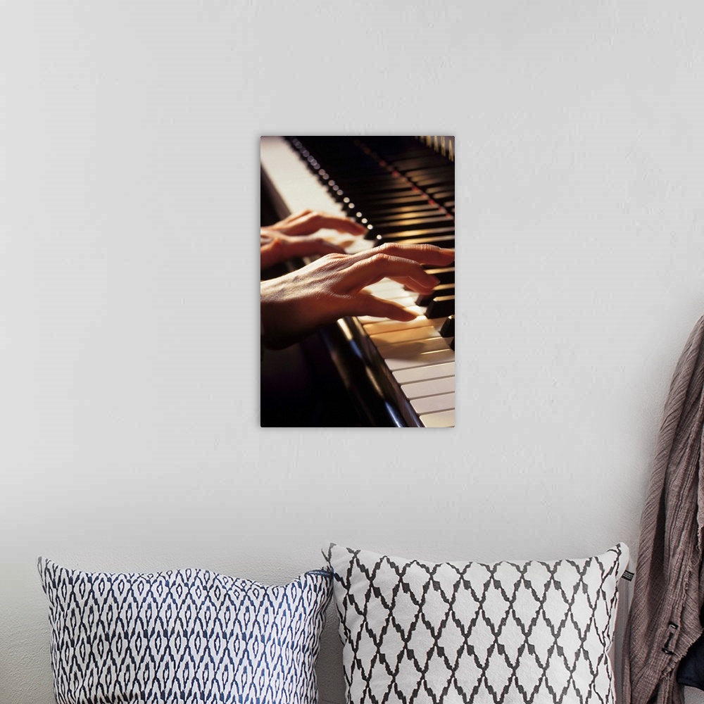 A bohemian room featuring Hands playing the piano