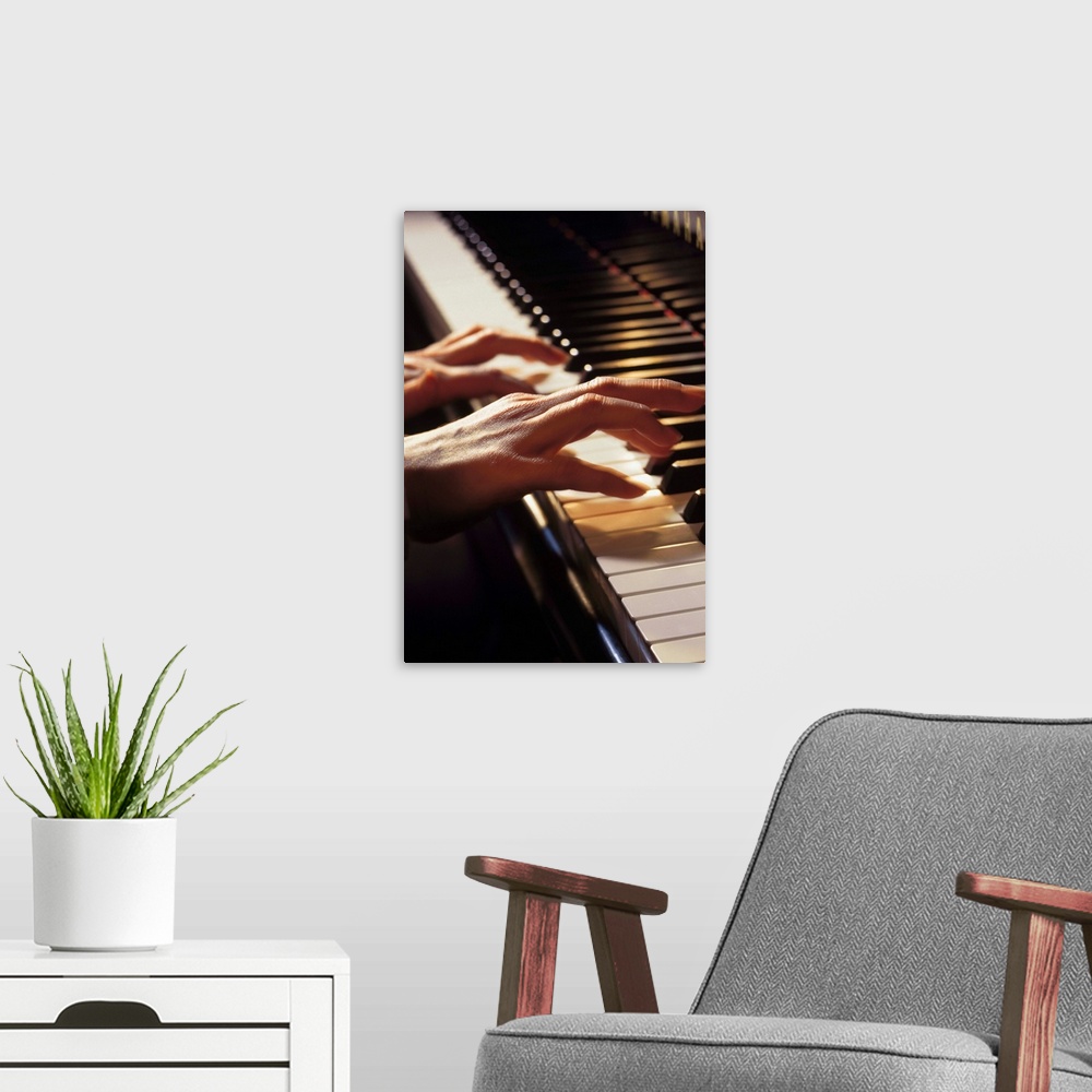 A modern room featuring Hands playing the piano