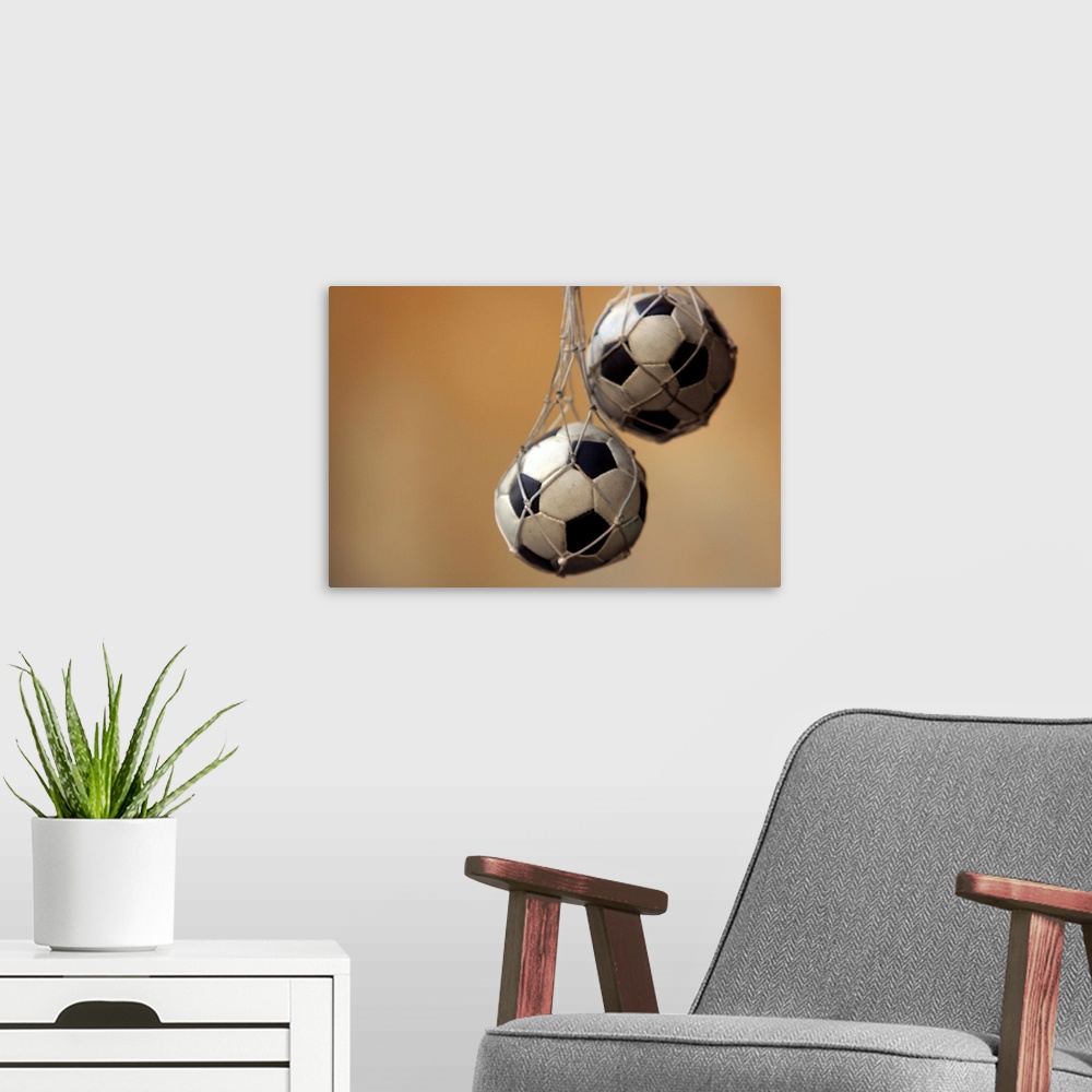 A modern room featuring Hanging soccer balls