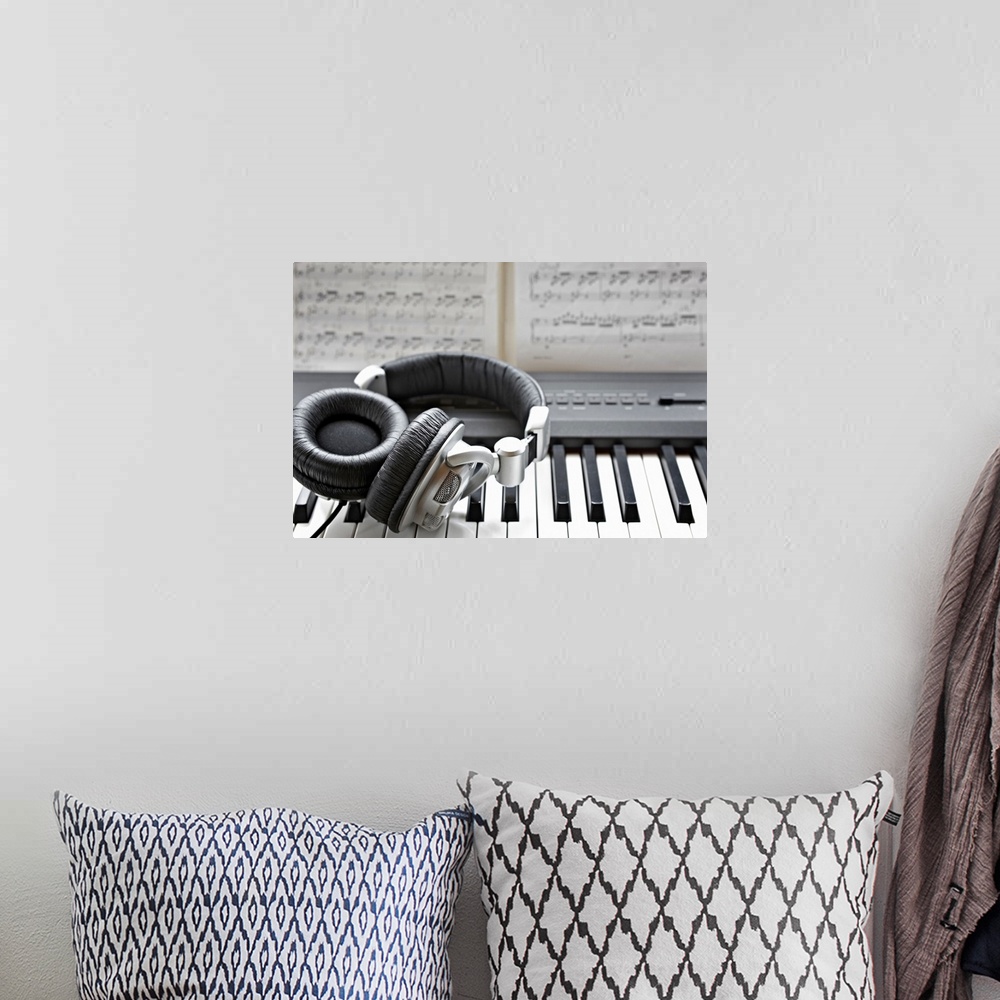 A bohemian room featuring Headphones on electronic piano keyboard
