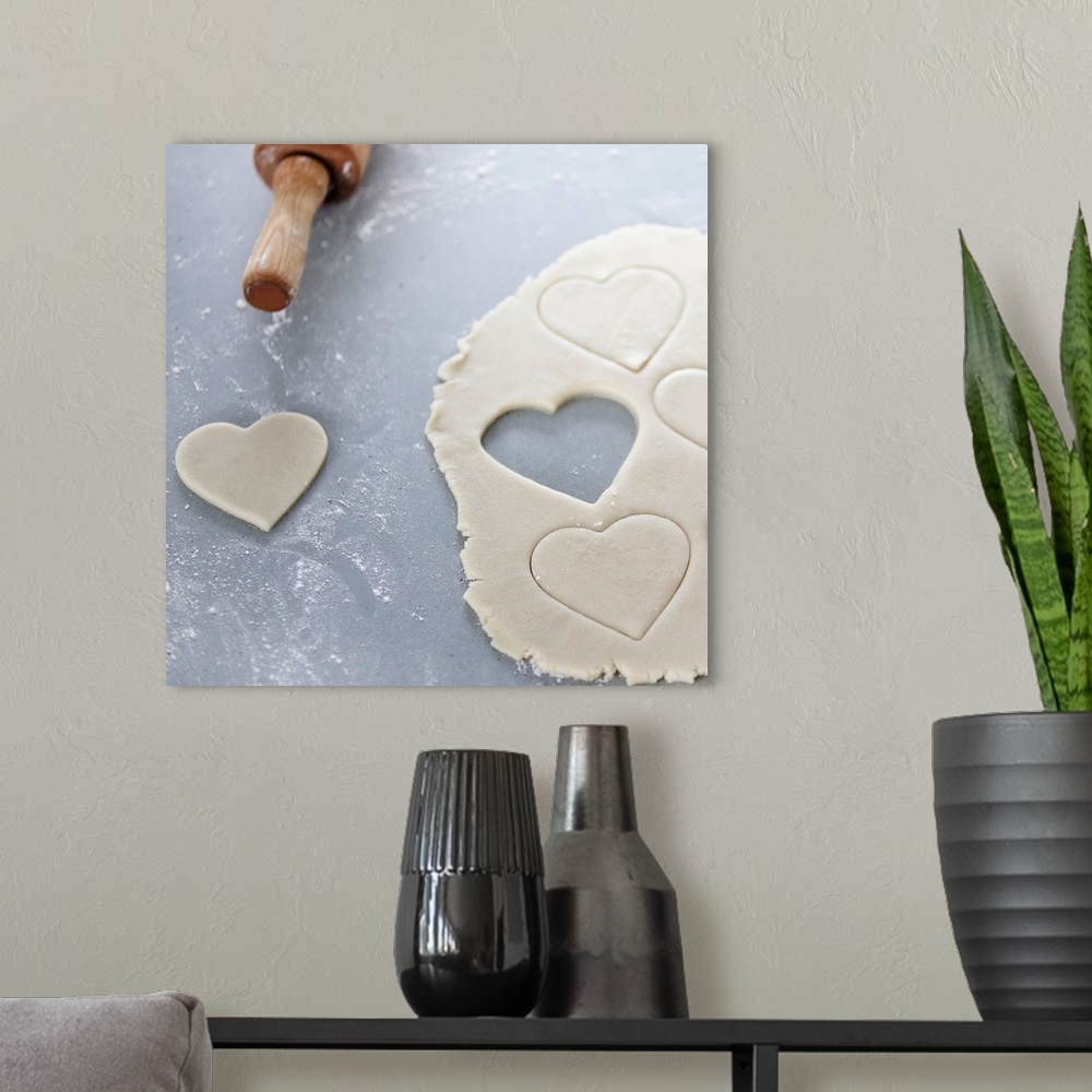 A modern room featuring Heart shape cut out of a sheet of rolled out cookie dough