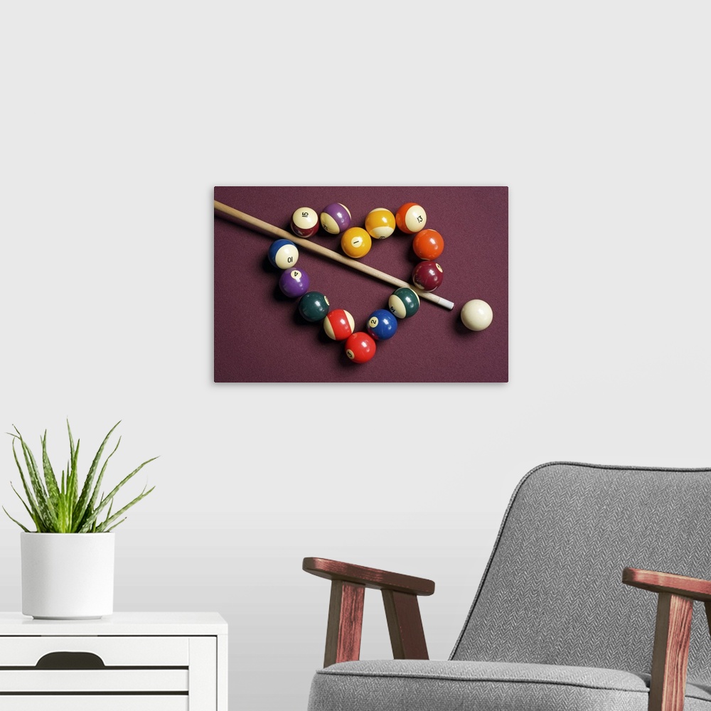 A modern room featuring Heart shaped billiard balls with cue ball and stick