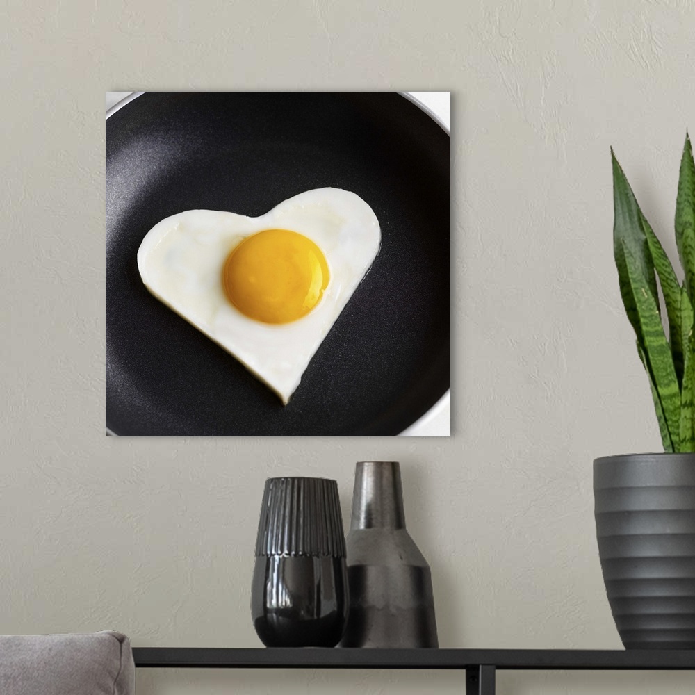 A modern room featuring Heart-shaped fried egg in skillet