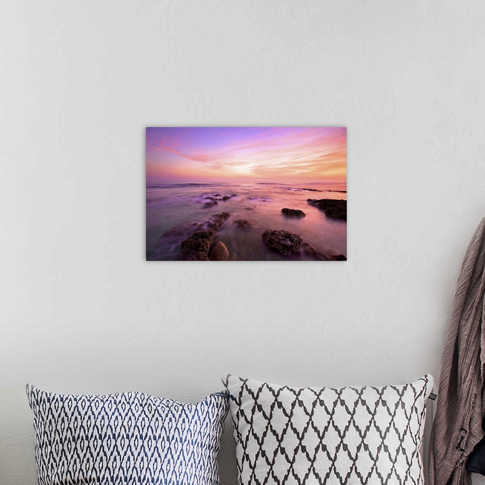A bohemian room featuring Purple clouds spreading above Wanliton sky at dusk and sea water crashing on coral reefs; in Ping...
