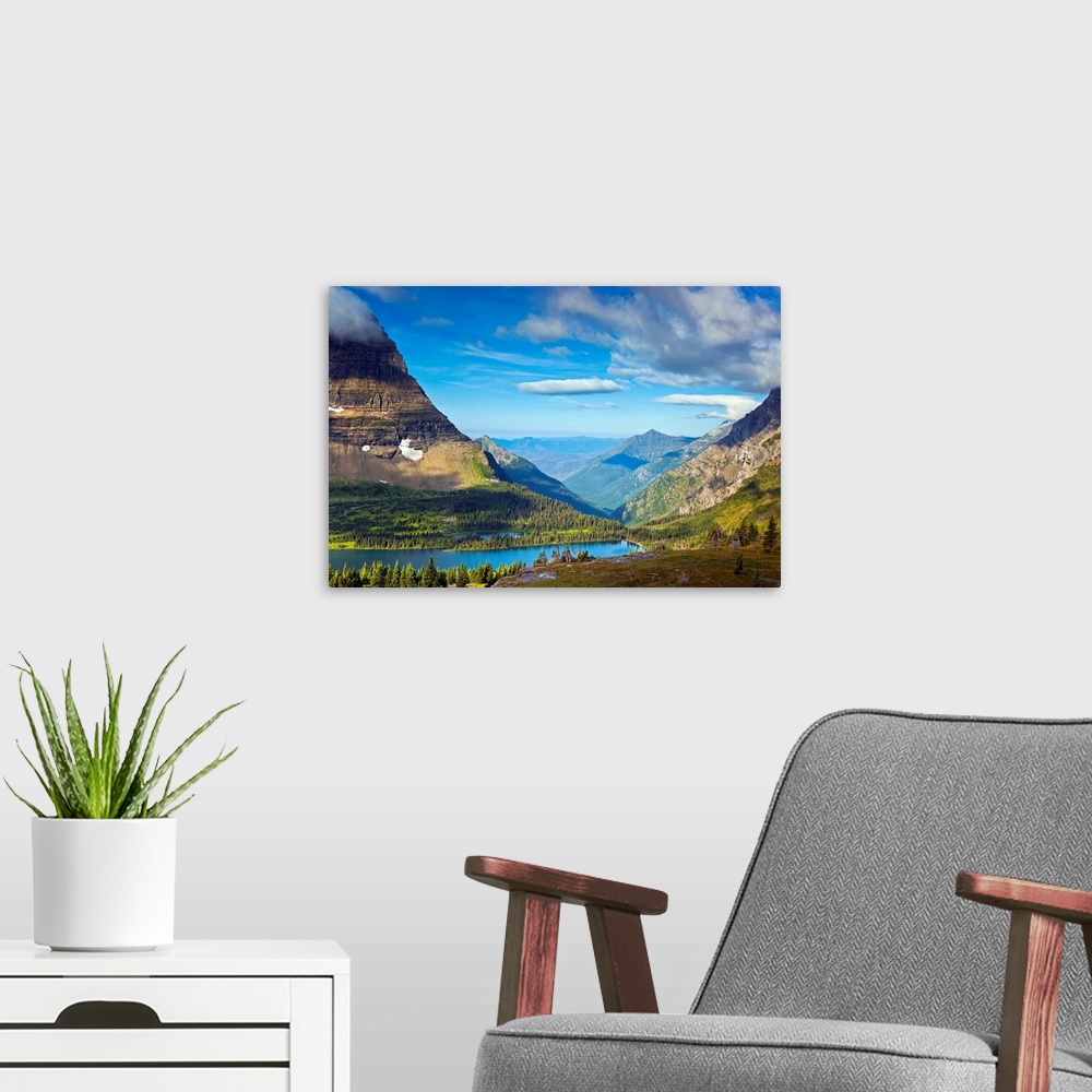 A modern room featuring Large, landscape photograph of  Hidden Lake from an overlook, surrounded by mountains in Glacier ...