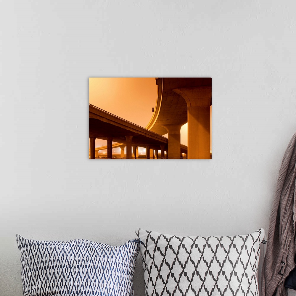 A bohemian room featuring Concrete supports of towering highway overpasses leading into downtown on a foggy spring night.