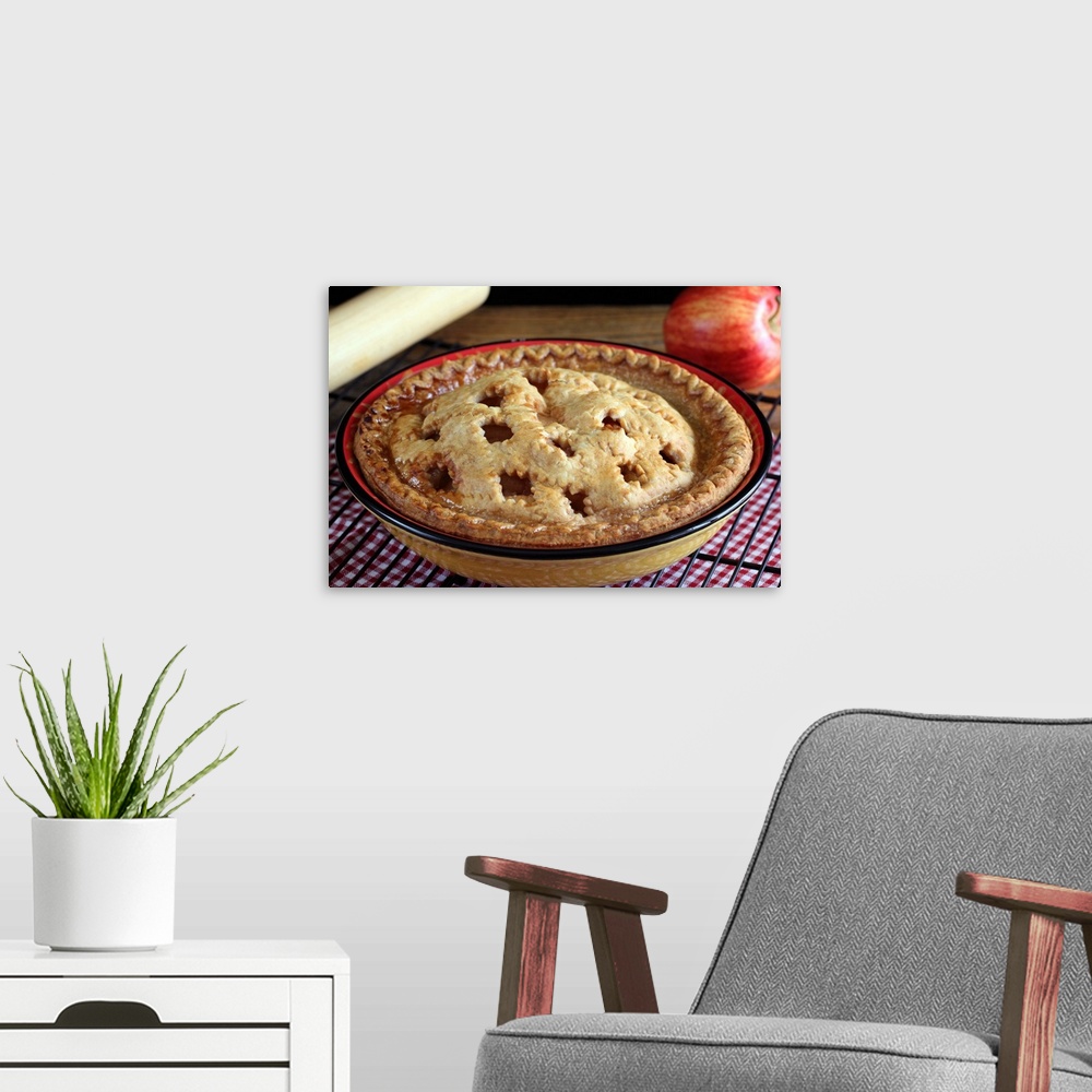 A modern room featuring Home baked apple pie on cooling rack with apple and rolling pin