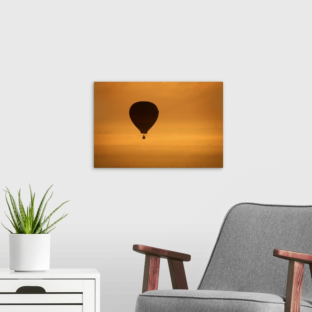 A modern room featuring Hot air balloon flying at dusk