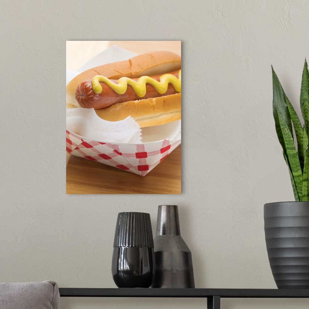 A modern room featuring Hot dog with mustard in paper dish