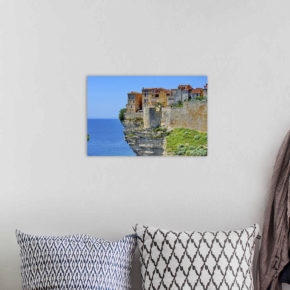 A bohemian room featuring Houses at Bonifacio in Corsica is built on cliff.