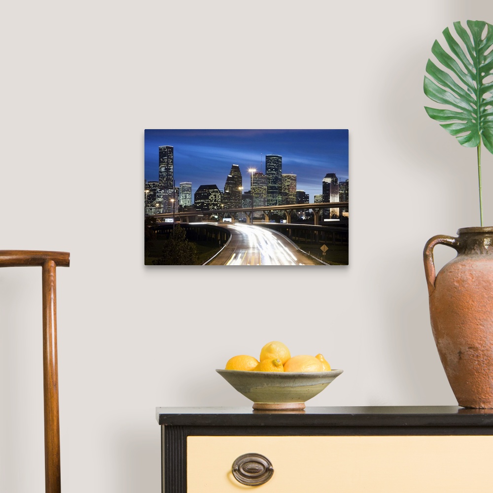 A traditional room featuring Houston skyline at dusk with freeway in foreground